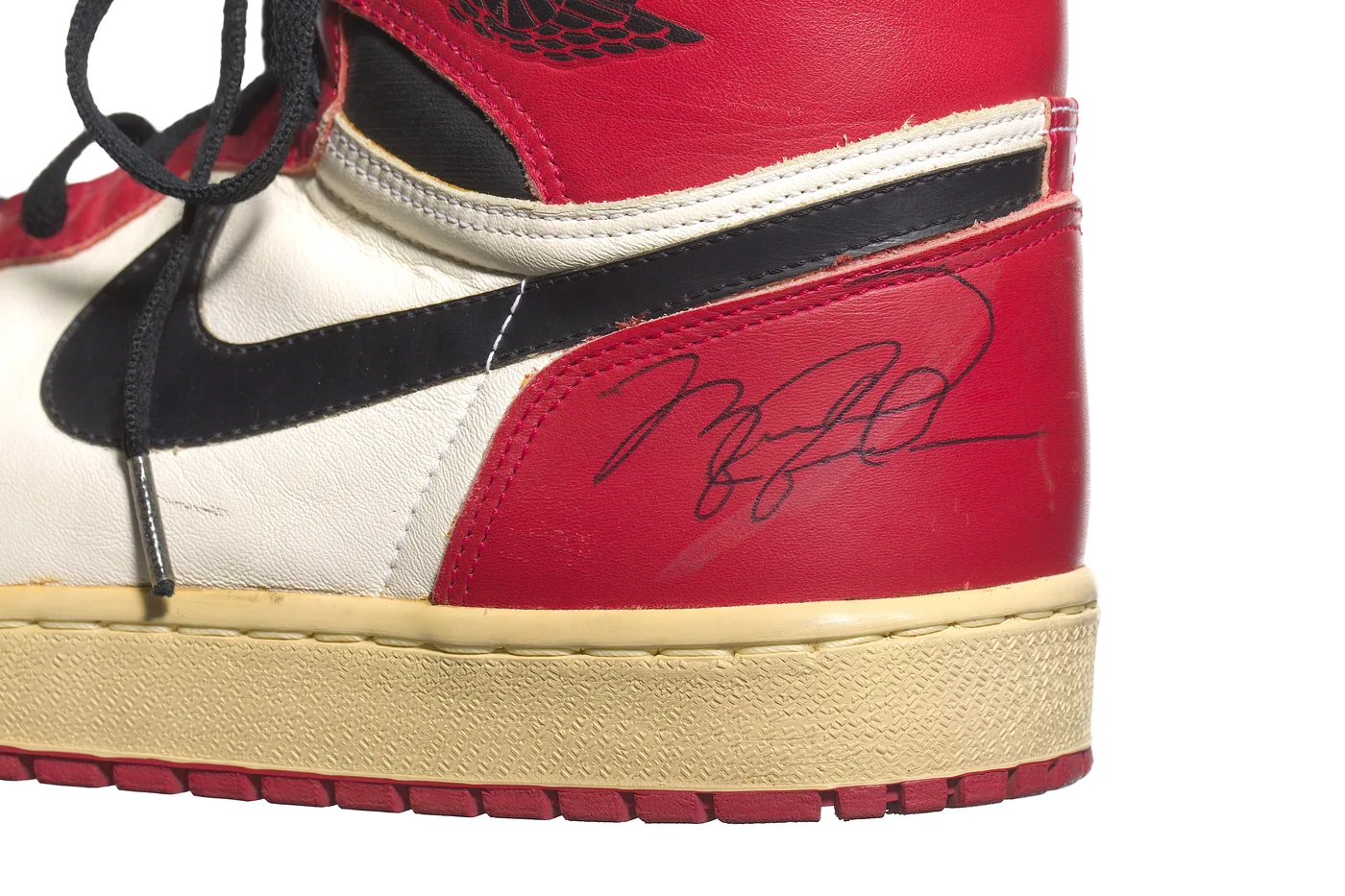 Michael Jordan's signature on the heel of a game-worn 1985 Air Jordan 1 in red, white and black