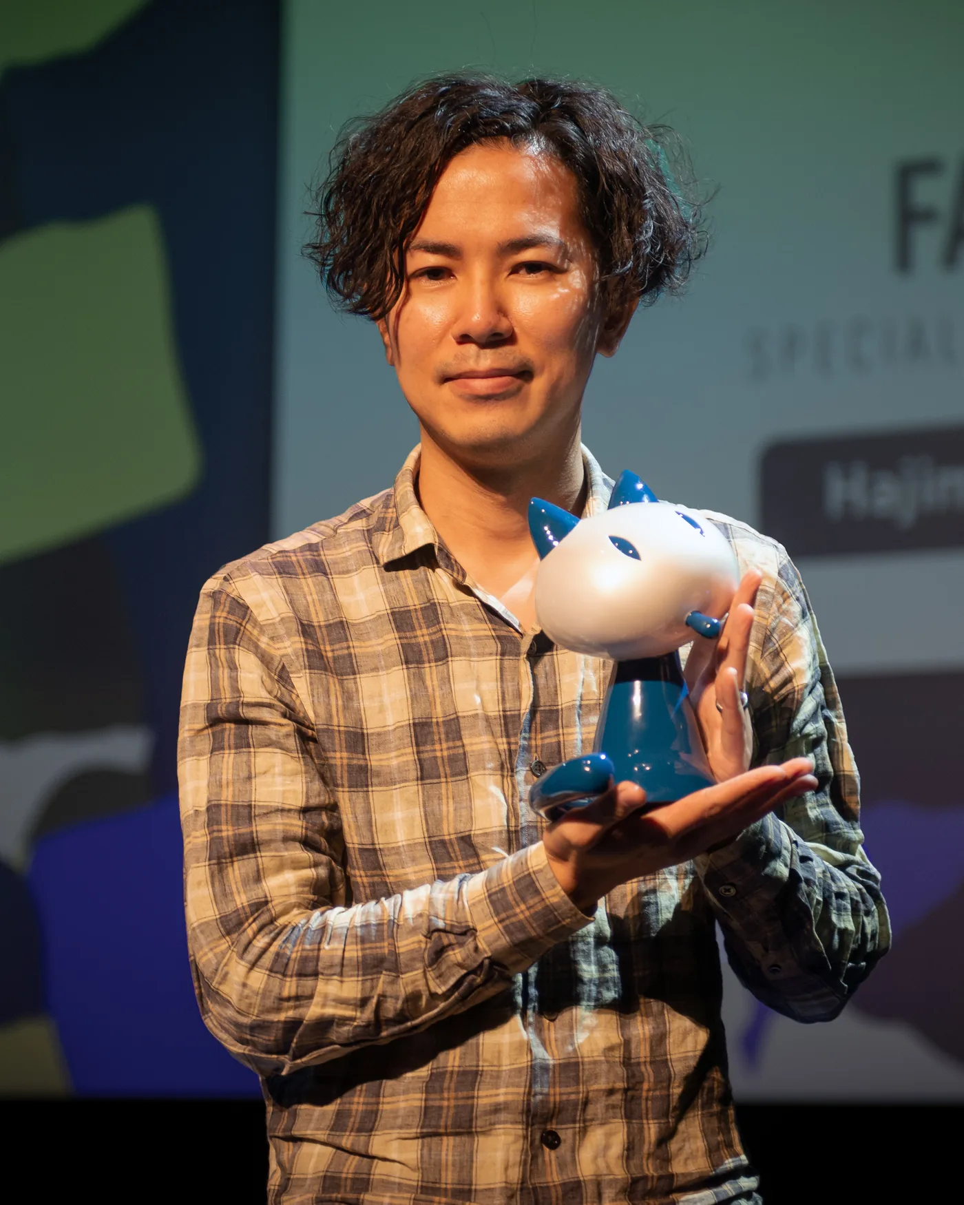 Hajime Isayama, creator of Attack on Titan, holding an award at the Angouleme comics festival in 2023