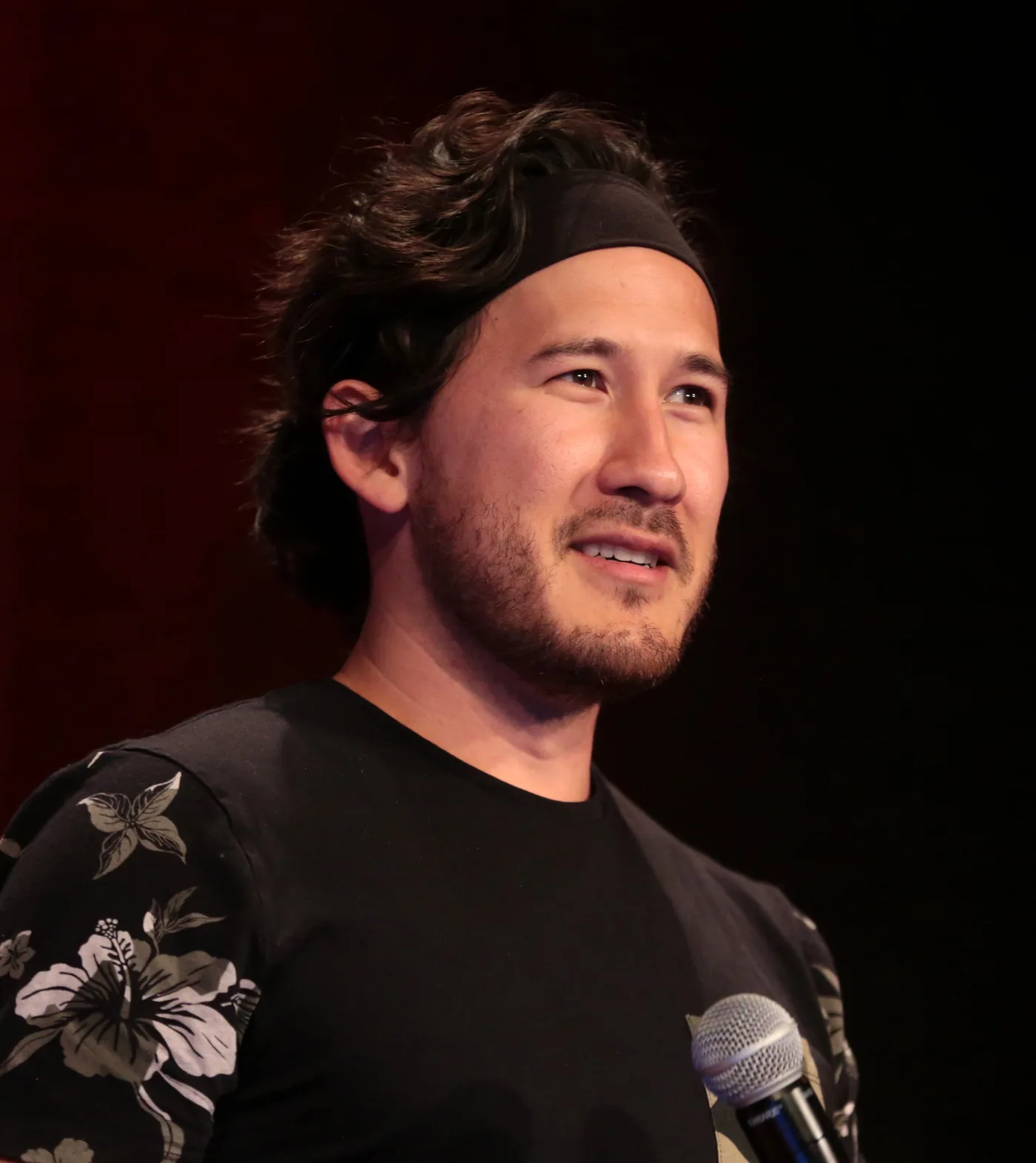 Markiplier, Mark Fischbach, holding a microphone on stage in 2018