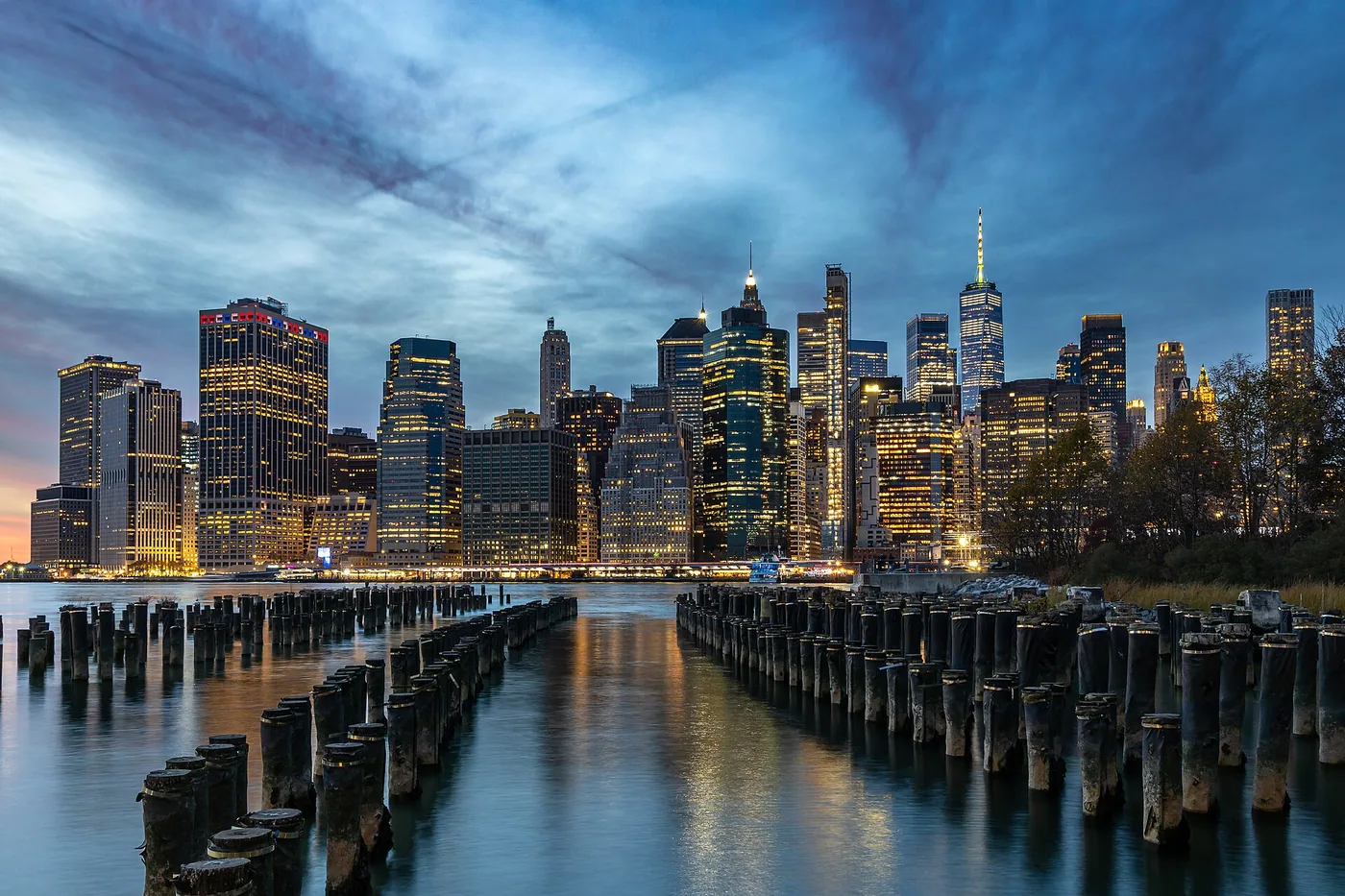 Lower Manhattan skyline at dusk, seen across the East River from Brooklyn