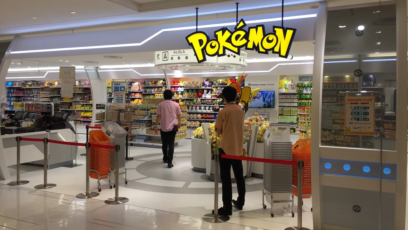 A Pokémon Center store inside a Japanese shopping centre, its logo lit above the entrance