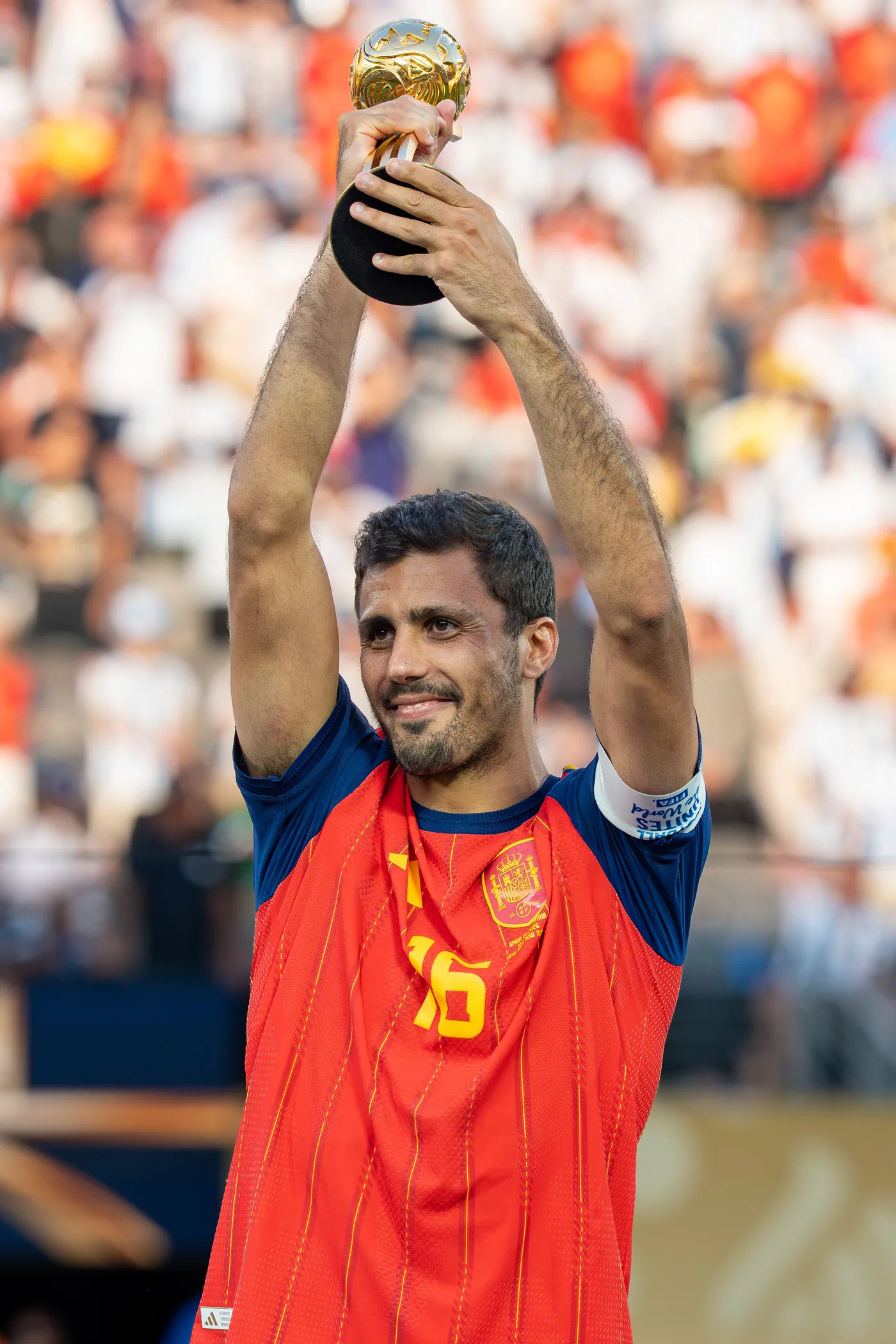 Rodri of Spain lifting the 2026 World Cup Golden Ball trophy in his number 16 shirt